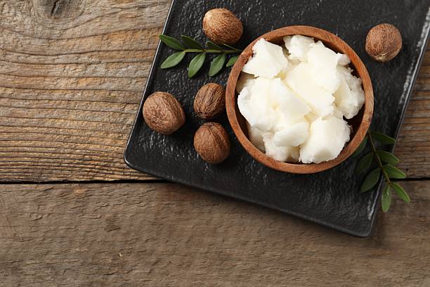 istock Natural shea butter and nuts on wooden table, top view 2211846761