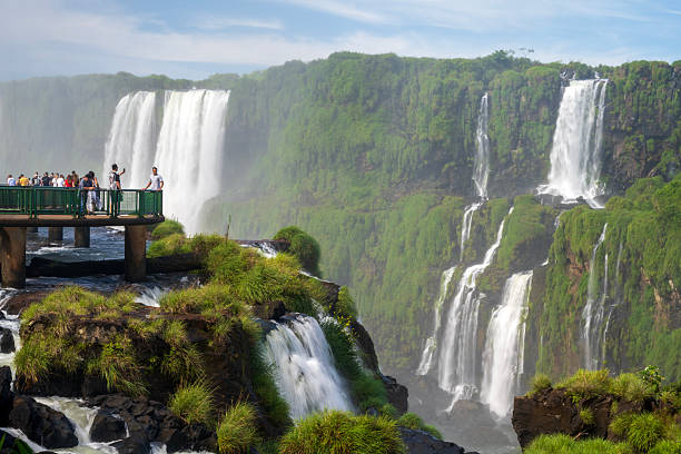 Foz do Iguacu, Brazil - March 14, 2025. Tourists on boardwalk at Iguacu Falls, Brazil.