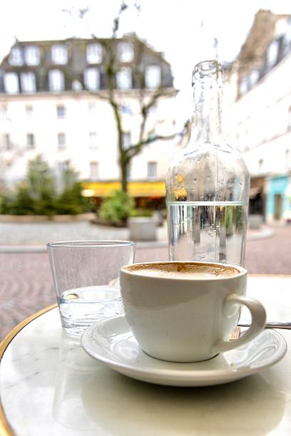 istock Latte with water bottle in a Paris cafe 2211851040