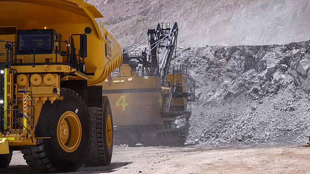 istock Heavy mining machinery extracting minerals in an open pit mine 2211866604