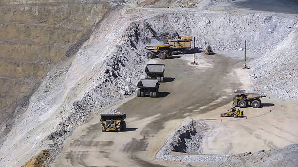 istock Heavy mining machinery extracting minerals in an open pit mine 2211866657