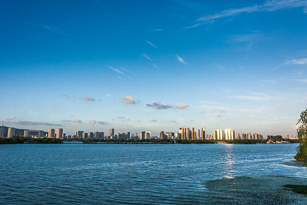 istock Captivating City Skyline Reflected in Tranquil Waters at Dusk 2211867936