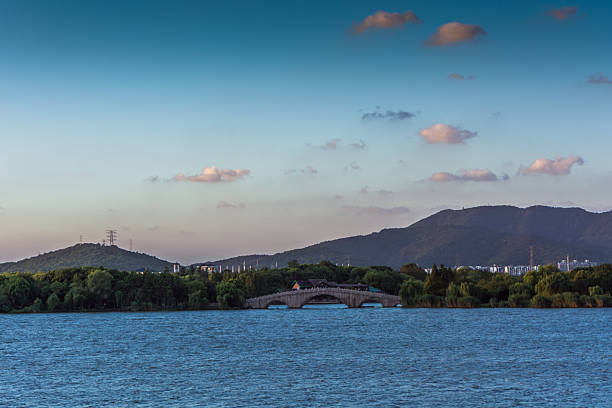 Serene River View with Elegant Bridge Against a Majestic Mountain Background
