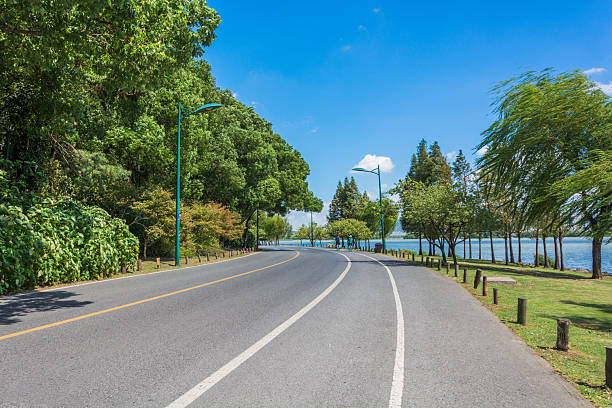 istock A Peaceful Scenic Roadside View by the Water with Lush Greenery 2211867986