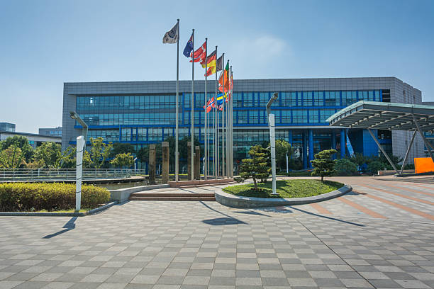 istock Striking Modern Office Building Displaying International Flags in Bright Sunshine 2211869134