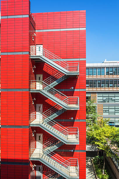 istock Captivating Modern Architecture: Vibrant Red Staircase Against Urban Backdrop 2211869150
