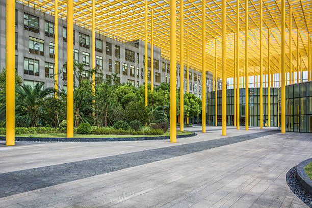 istock Striking Modern Pavilion with Yellow Framework and Lush Greenery in Radiant Urban Setting 2211869306