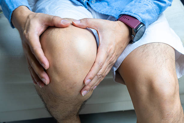istock Knee pain man He puts his hands on his knees, pain points from osteoarthritis and bone diseases, medical concepts and treatments. 2211870954