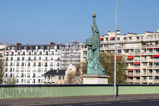 A scenic view of the Eiffel Tower and the Seine River from  Pont Alexandre III  bridge in Paris, France, featuring an ornate sculpture.