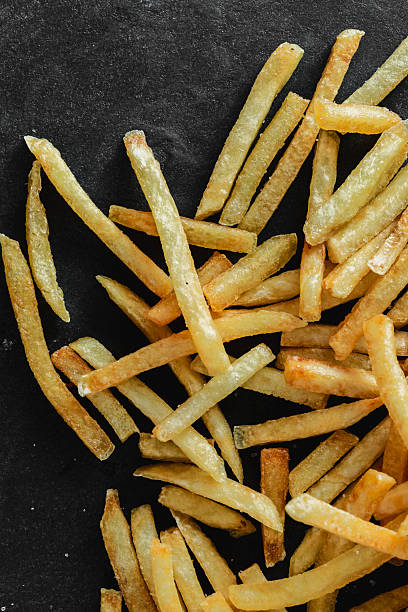 istock Golden Fried Potatoes Sticks on Dark Rustic Background for Snacks 2211874935