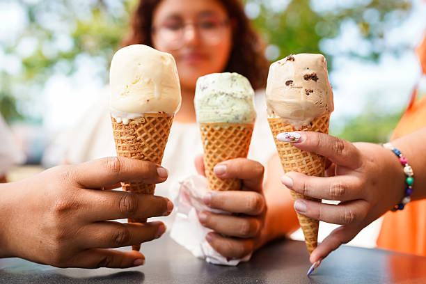istock Three latin women holding ice cream cones on a summer day 2211875048