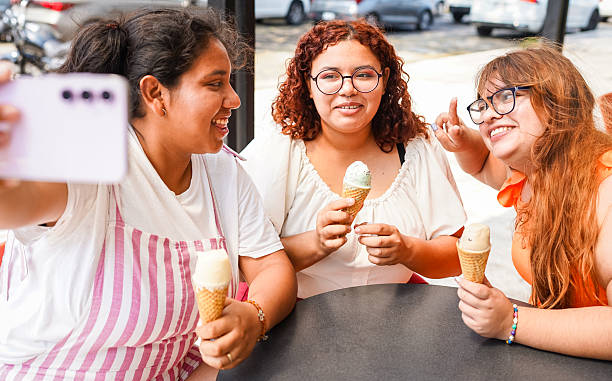 istock Latin women taking selfie while enjoying ice cream cones 2211875058