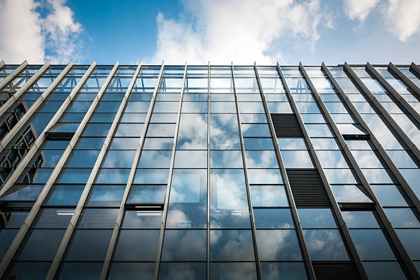 Captivating Modern Architecture: Reflections of Sky and Clouds on Glass Facade
