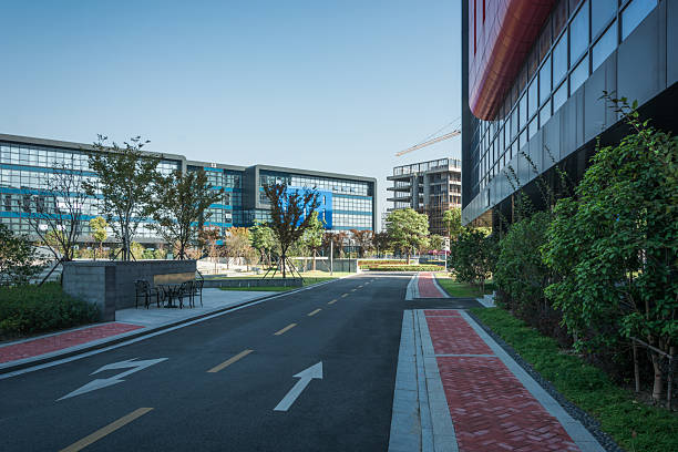 istock empty footpath with modern office building exterior and blue cloudy sky during sunrise 2211878352