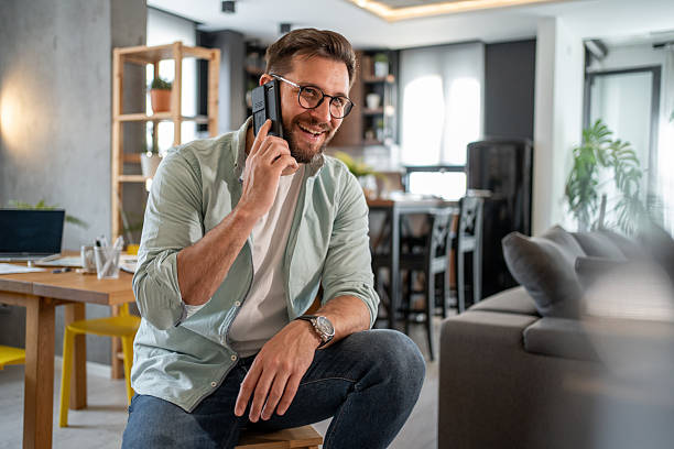 istock Smiling freelancer talking on the phone at home office 2211879196