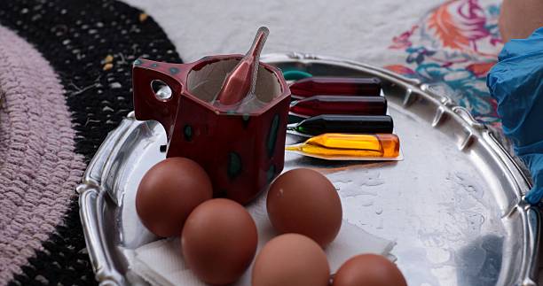 Coloring Easter eggs with red dye and vibrant hues for festive decorating celebrations