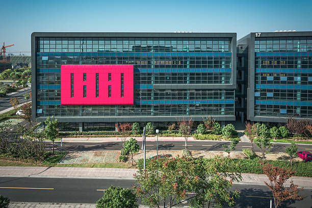 Modern Architectural Marvel Featuring Bold Pink Signage Against Glass Facade
