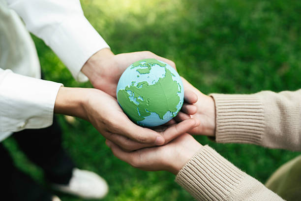 istock World Environment Day, hands holding earth globe to protect and save clean planet, Environmental care for sustainable.Green Business Save Earth and Eco Friendly. ESG and CSR concept to net zero 2211880592