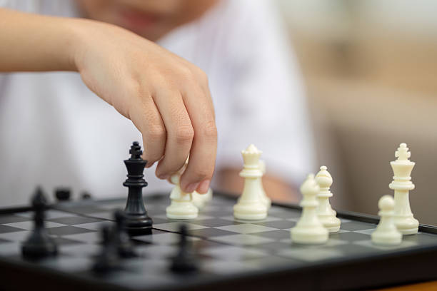 Activity mother and son focusing on chess strategy