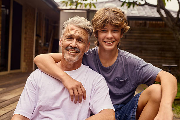 istock Happy father and son smiling together in Australian backyard 2211884938