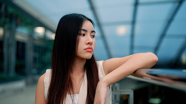 istock Young Asian woman feeling stressed from working too long at work. 2211886430