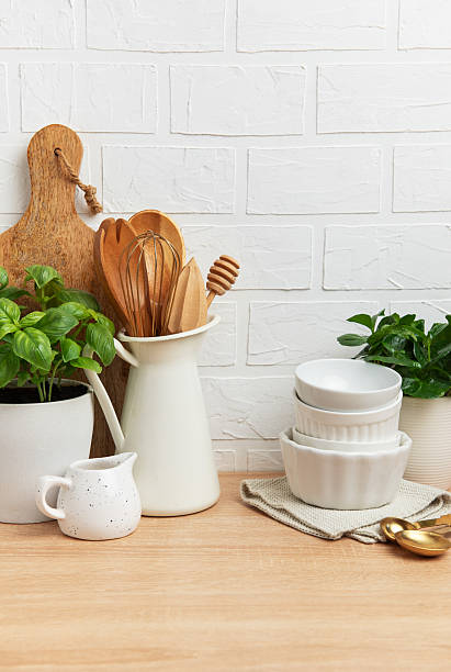 istock Kitchen utensils and plants creating cozy atmosphere on wooden countertop 2211887463