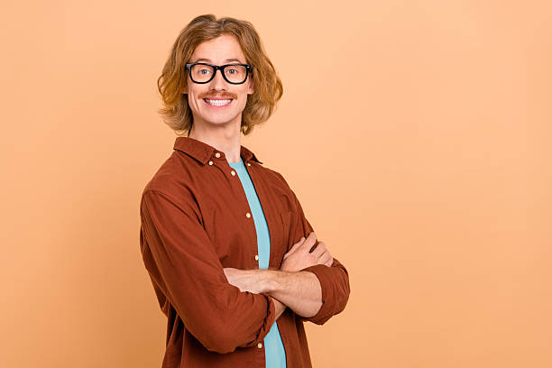 istock Profile side view portrait of attractive content cheeful smart red-haired guy folded arms copy space isolated over beige pastel color background 2211888366
