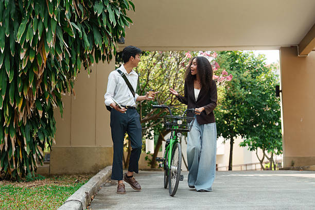 istock Sustainable Transportation and Collaboration. Two friends engage in a conversation about eco-friendly commuting options. 2211889362