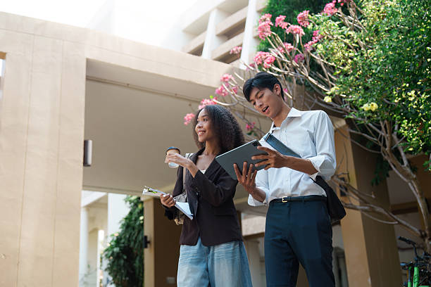 istock Modern Work and Sustainability. A woman and man exploring digital solutions for sustainable practices in a serene outdoor space. 2211889789