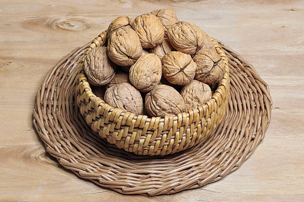 istock Close up walnuts in a wicker bowl 2211890732