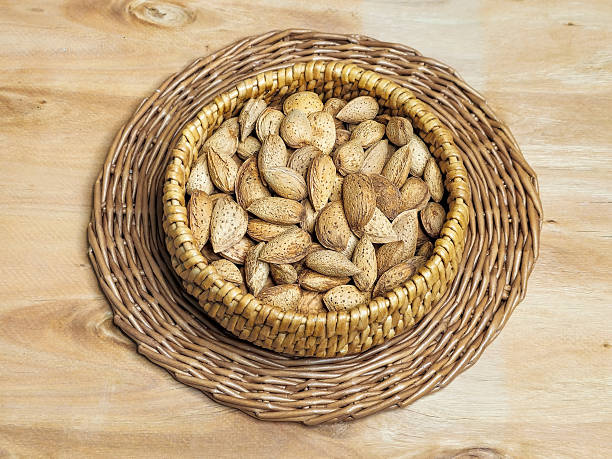 istock Close up inshell almonds in a wicker bowl 2211890742