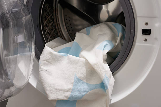 istock Washing machine with dirty clothes inside, closeup. Housework concept 2211891568