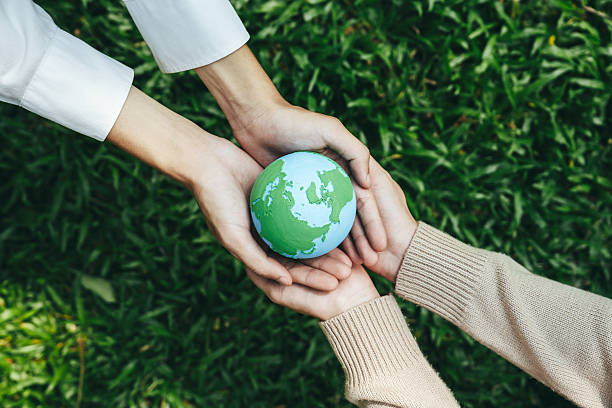 istock World Environment Day, hands holding earth globe to protect and save clean planet, Environmental care for sustainable.Green Business Save Earth and Eco Friendly. ESG and CSR concept to net zero 2211891834