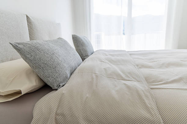 istock Modern Bedroom with Neutral Tones and Soft Pillows 2211892199