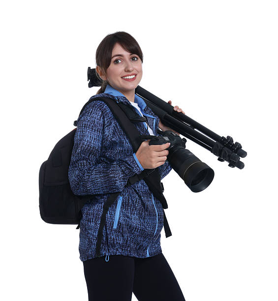 Active aged woman is taking video next to forest lake with her wearable camera