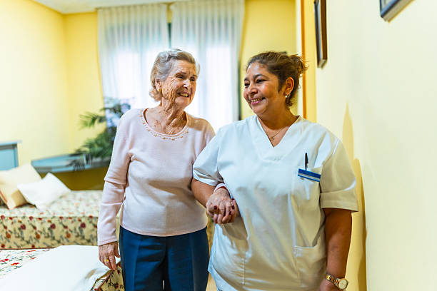 istock Nurse assisting elderly woman in nursing home 2211892985