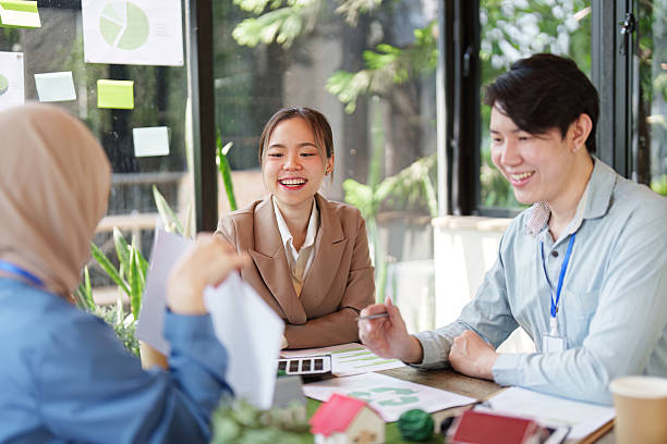 istock Collaboration and Sustainability. Professionals discussing sustainable solutions at a green workspace with eco-friendly materials. 2211893484