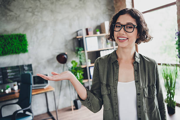 istock Young female specialist in stylish office representing success in programming and technology, showcasing modern work trends 2211894155