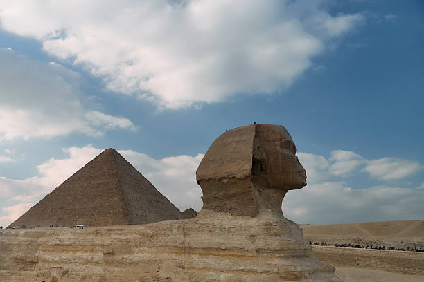 A trip around the pyramids of Giza in Cairo, Egypt. The Sphinx and tourists share the desert and the famous monuments. It was in October on a sunny day