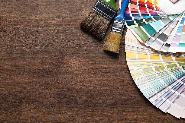 istock Color selection charts and paint brushes on wooden table, flat lay with space for text. Decorating and design 2211895330
