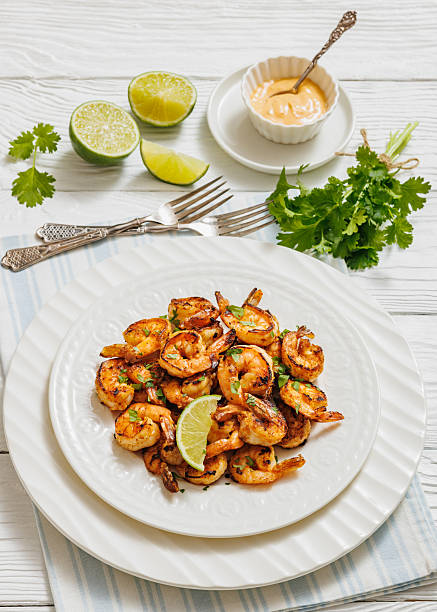 istock Grilled shrimp on a white plate with lime 2211895999