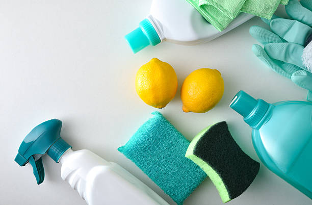 istock Household cleaning products in white and green tones on table 2211896132