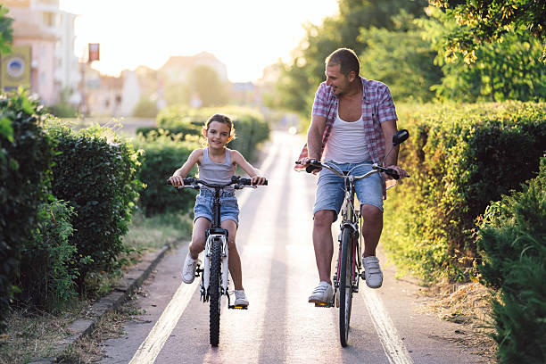 istock Cheerful biking, a father-daughter adventure moment 2211896283