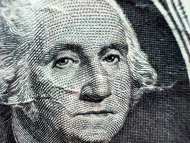 istock George Washington's disgruntled face in close-up macro on dollar bill in grayscale 2211897126