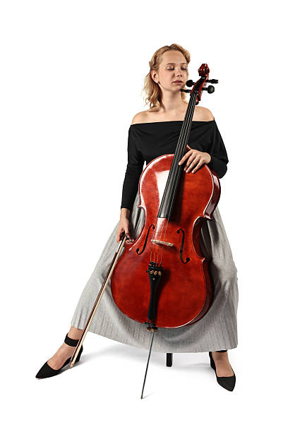 istock Beautiful young woman playing cello on white background 2211897299