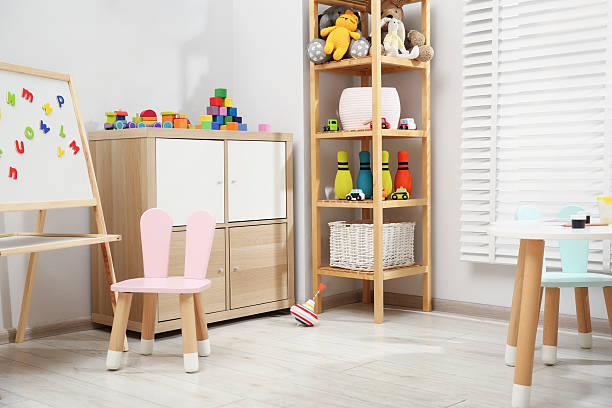 istock Table with paints and different toys in child's room 2211897437