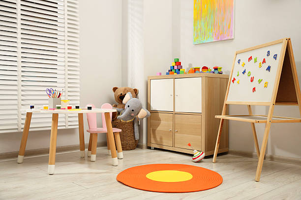 istock Table with paints and different toys in child's room 2211897439