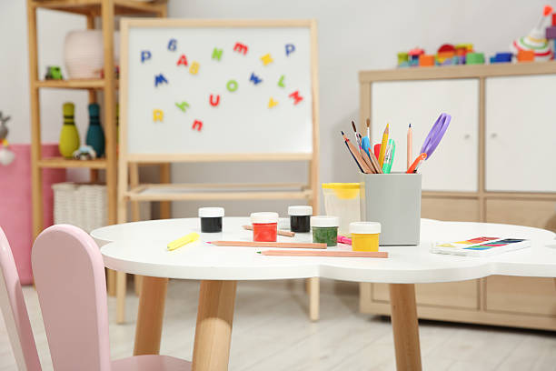 istock Table with paints and other stationery in child's room 2211897440