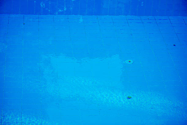 A close-up, macro shot capturing the fine details of a swimming pool scene—sparkling water, textured surfaces, and reflections of light—bringing summer vibes to life.