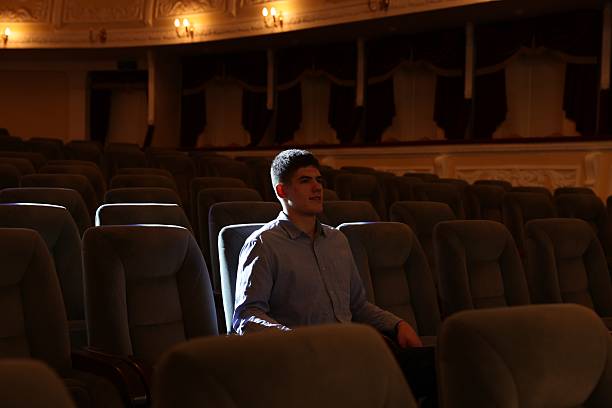 istock Young man watching theatrical performance in theatre 2211899807